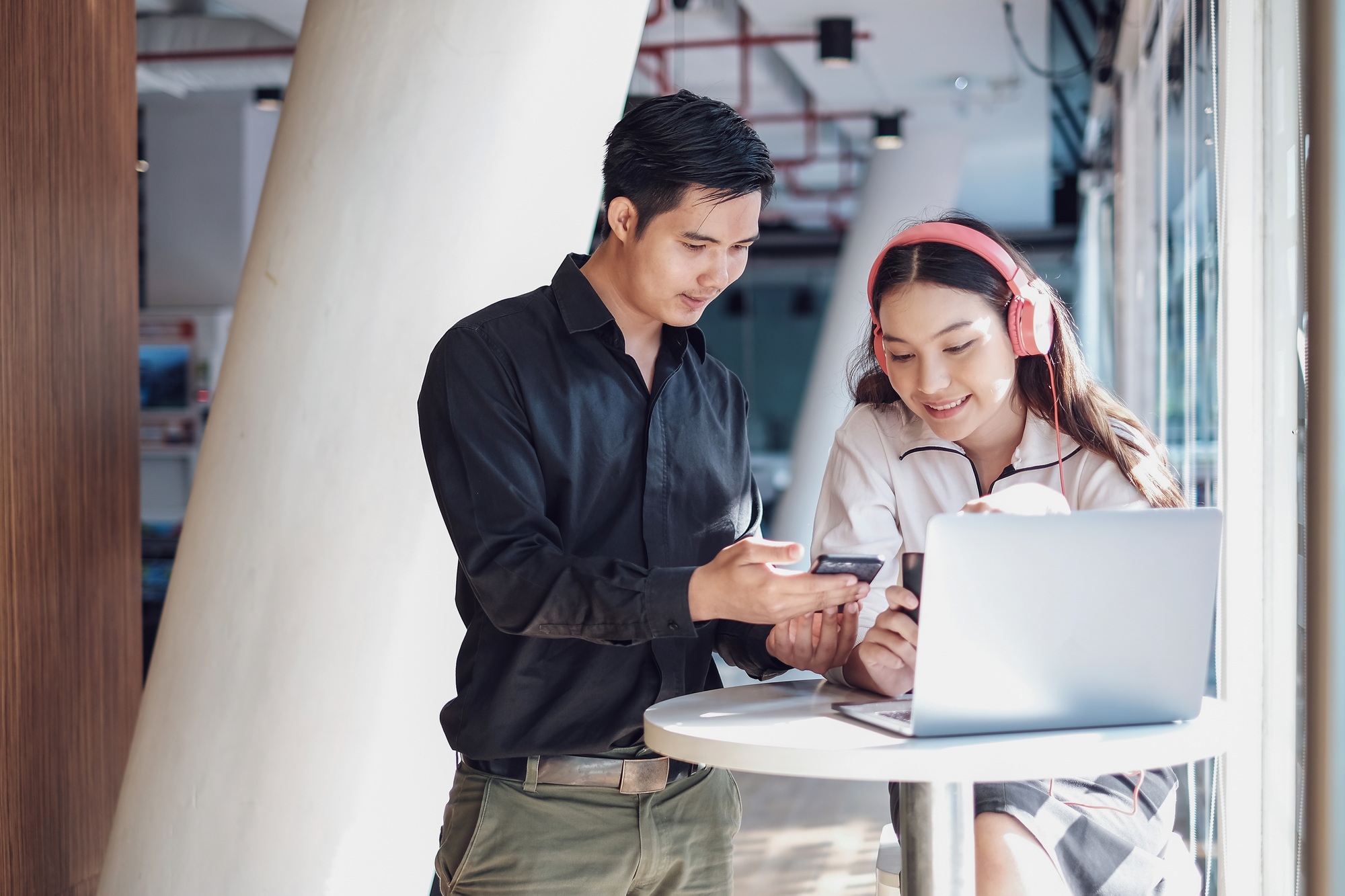 Young asian business people working together on a modern office project.